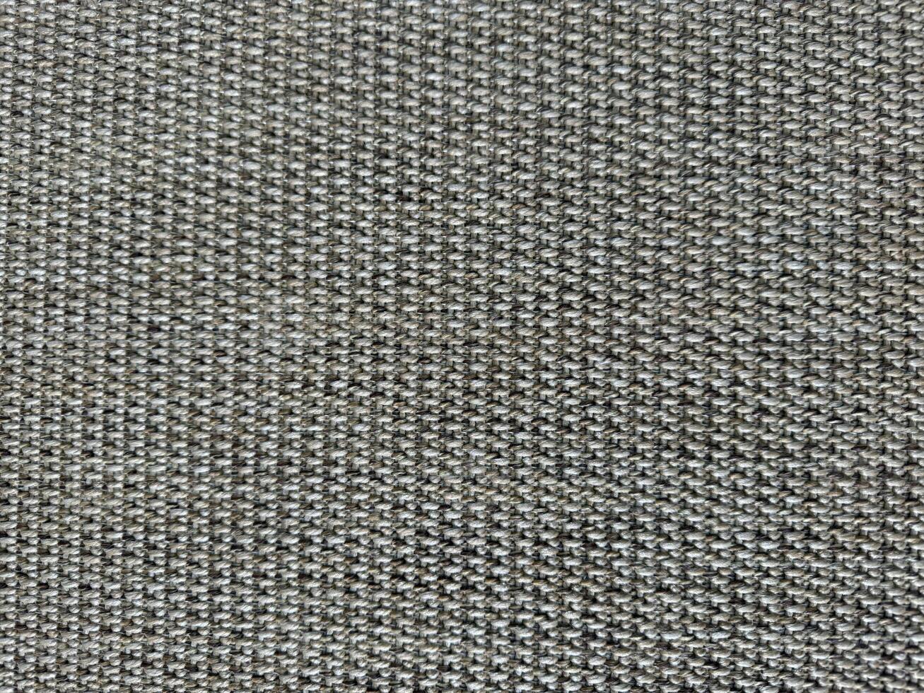 Detailed texture of gray woven fabric showcasing intricate patterns and threads photo