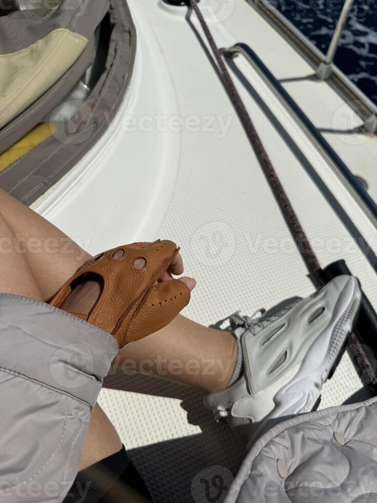 Sailing adventure with stylish gloves and sporty shoes on a sunny day at sea photo