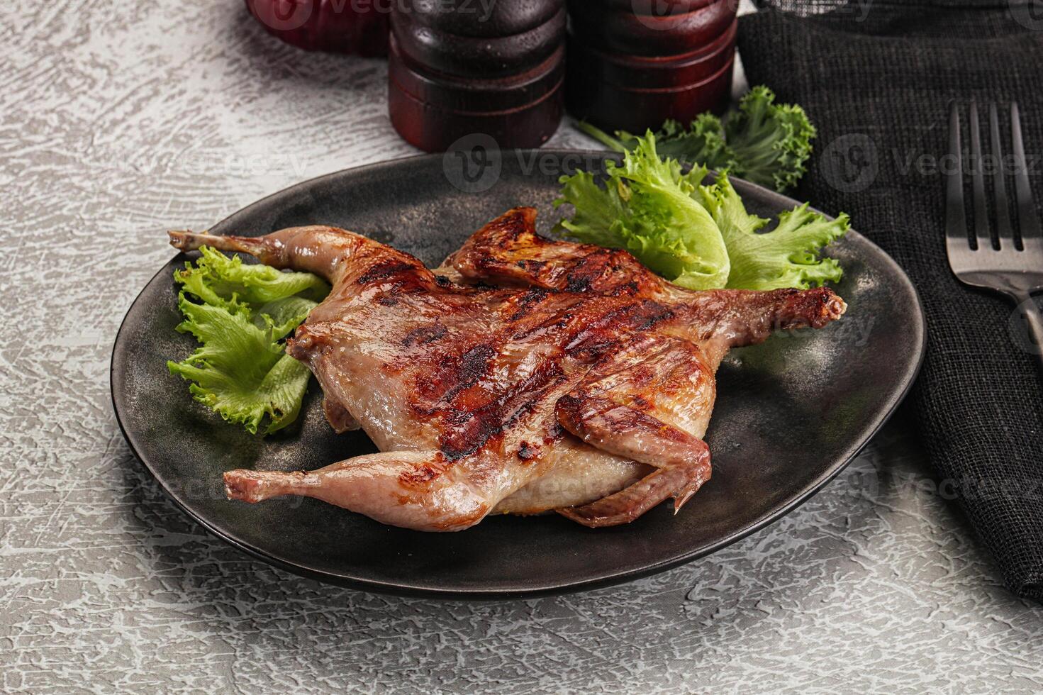 Grilled quail in the plate photo