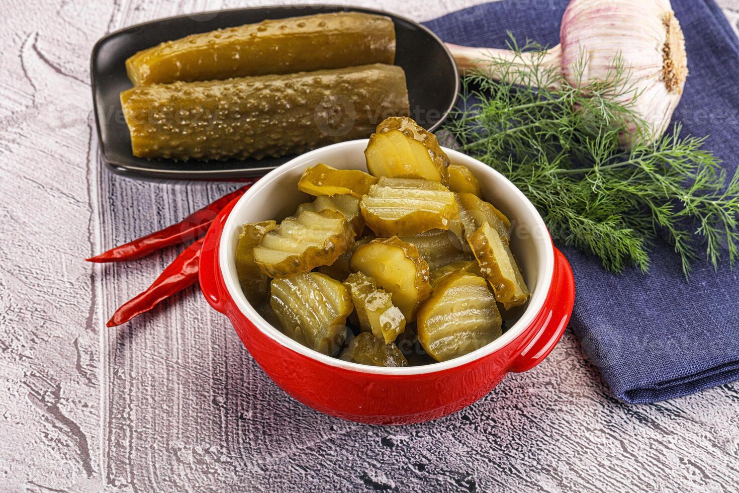 Sliced marinated cucumbers in the bowl photo