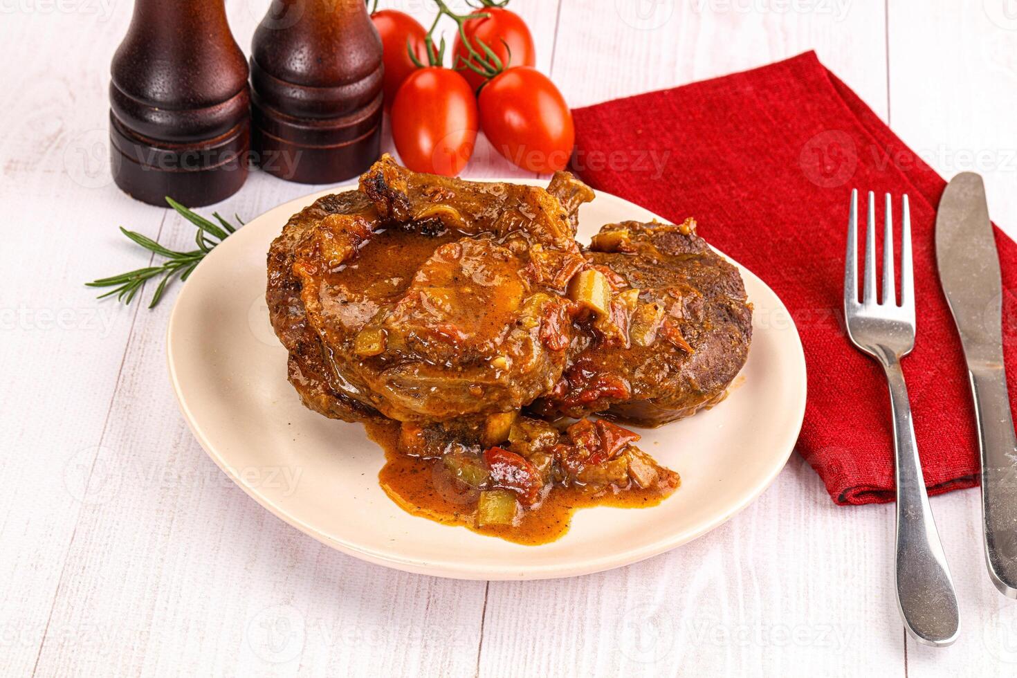 Italian cuisine - ossobuco with sauce photo