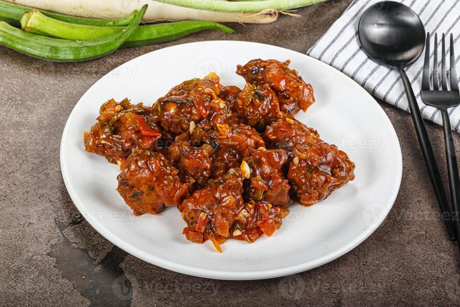 Manchurian chicken with sauce and spices photo