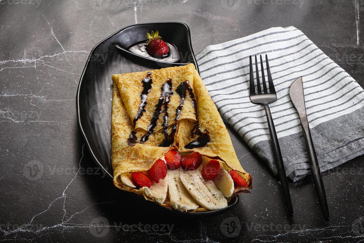 Sweet pancake with banana and strawbeery photo