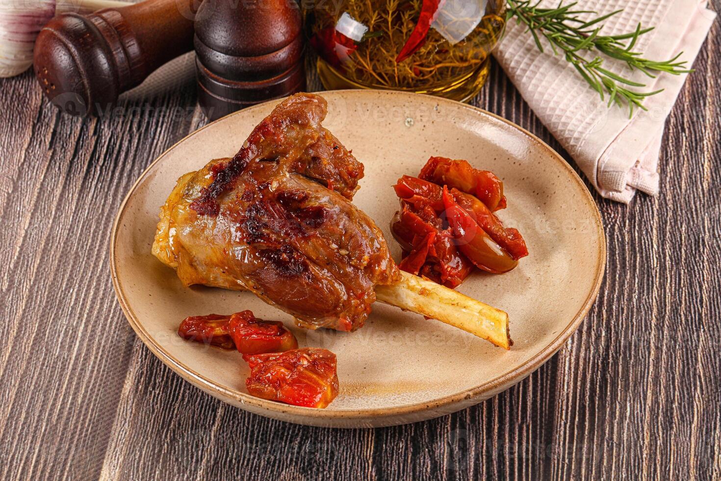Baked lamb shank with vegetables photo