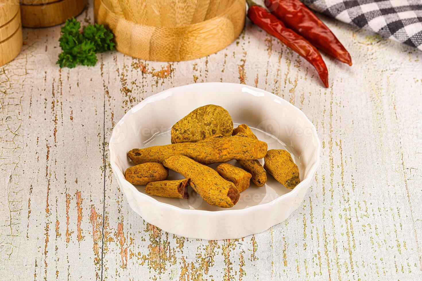 Raw dry Tumeric roots heap photo