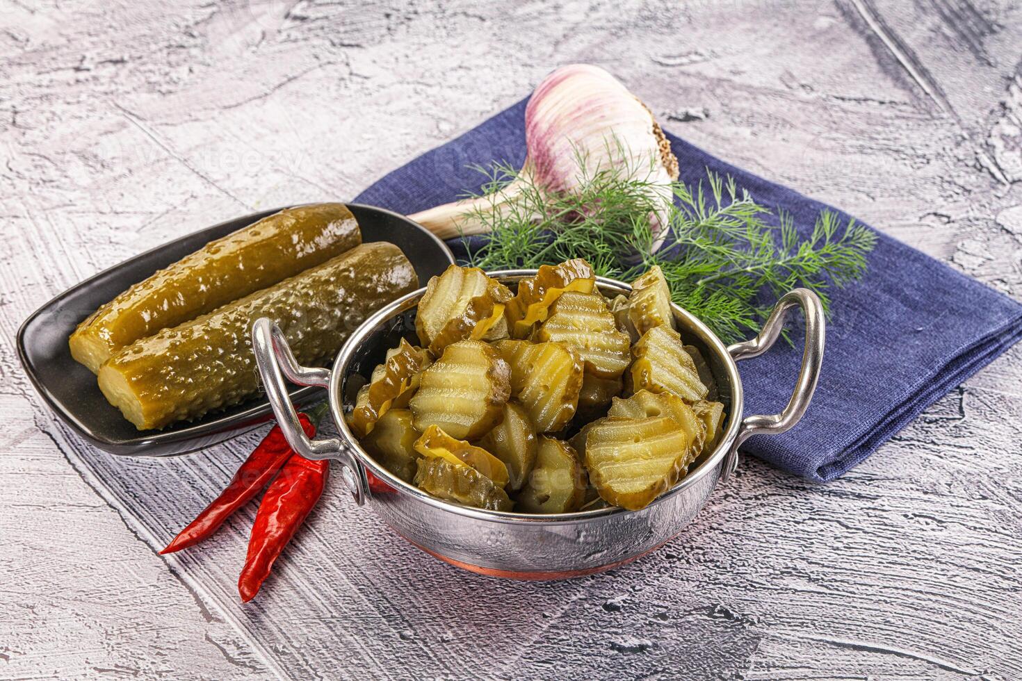Sliced marinated cucumbers in the bowl photo