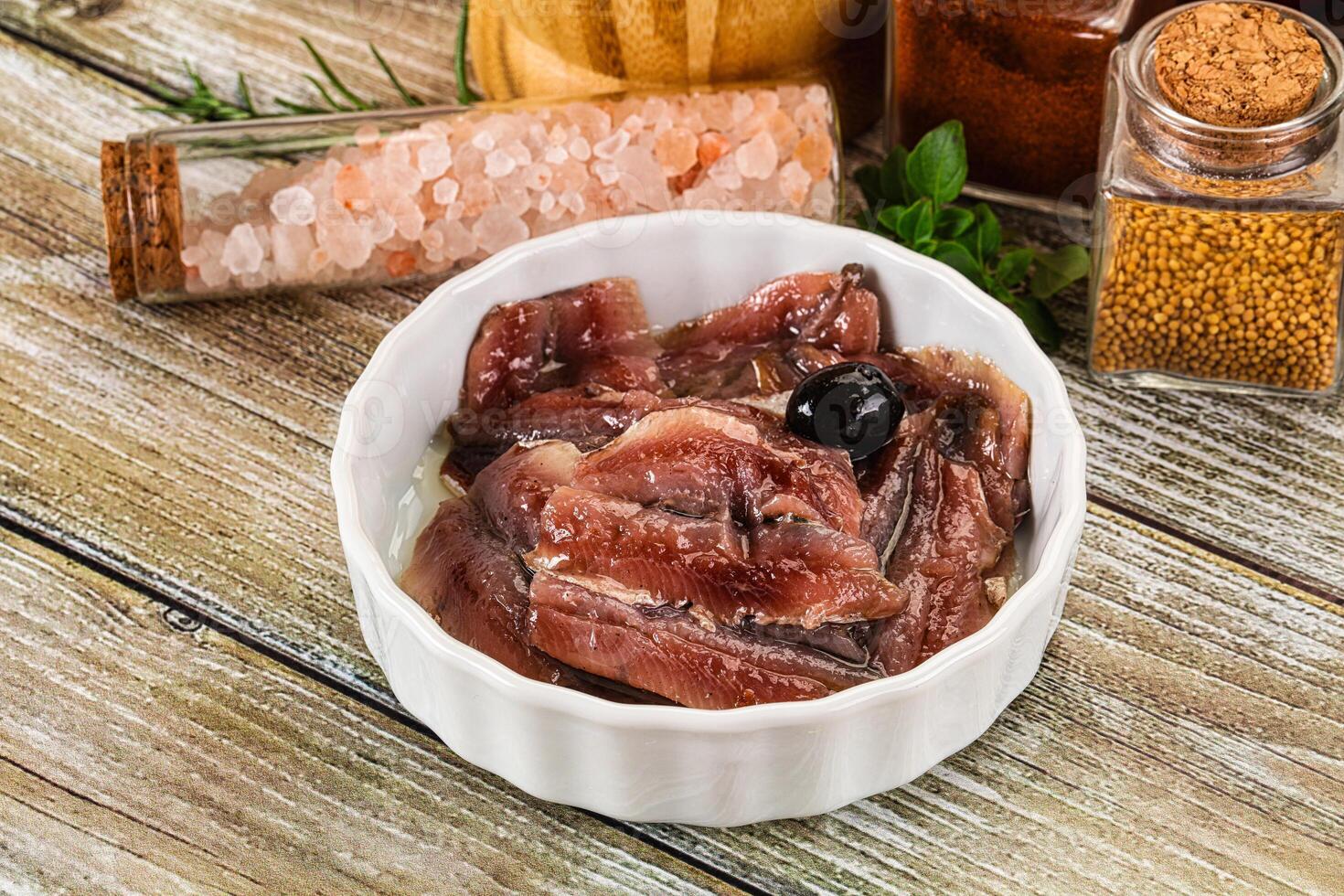 Canned anchovy with oil in the bowl photo