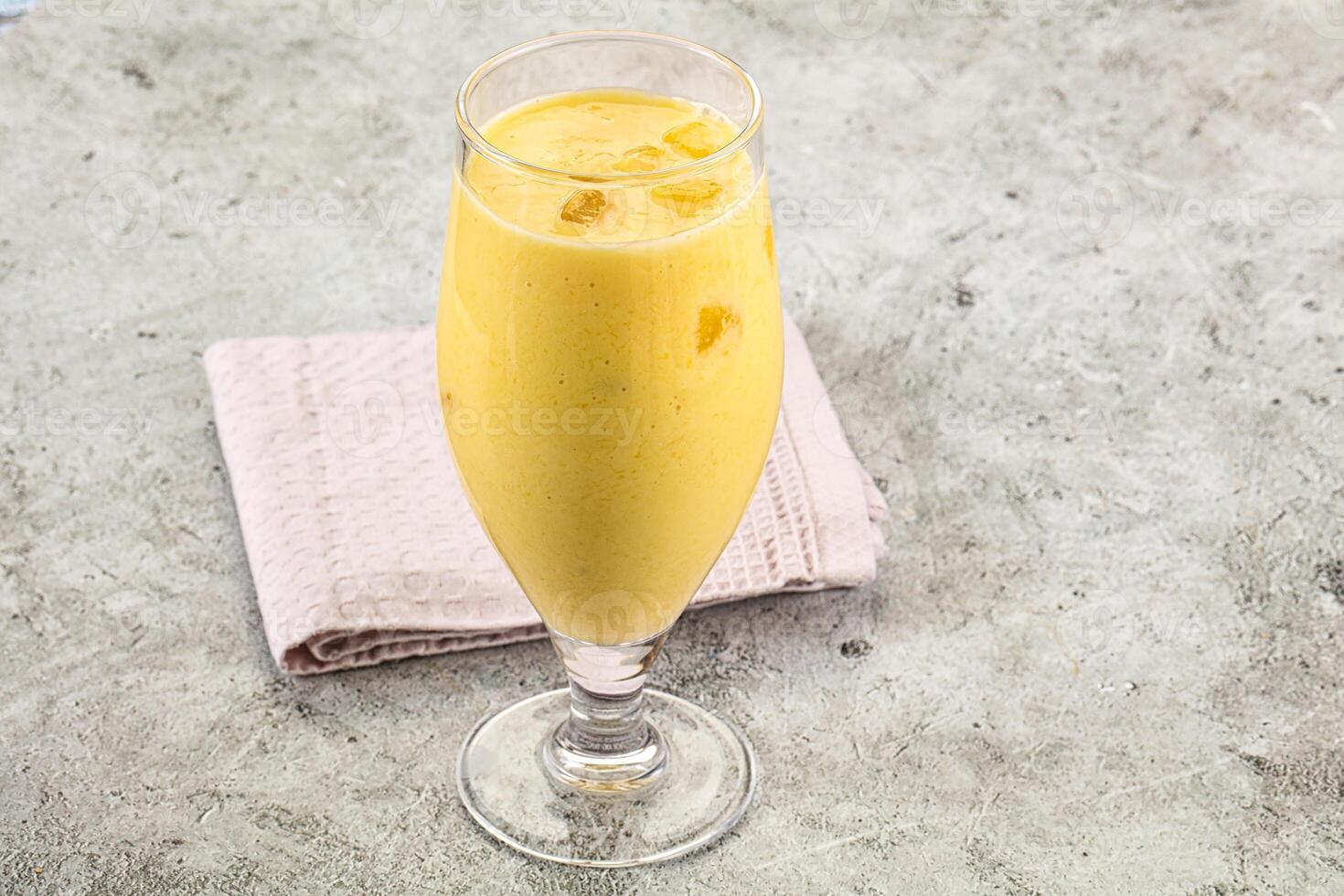 Cold sweet mango smoothie glass photo