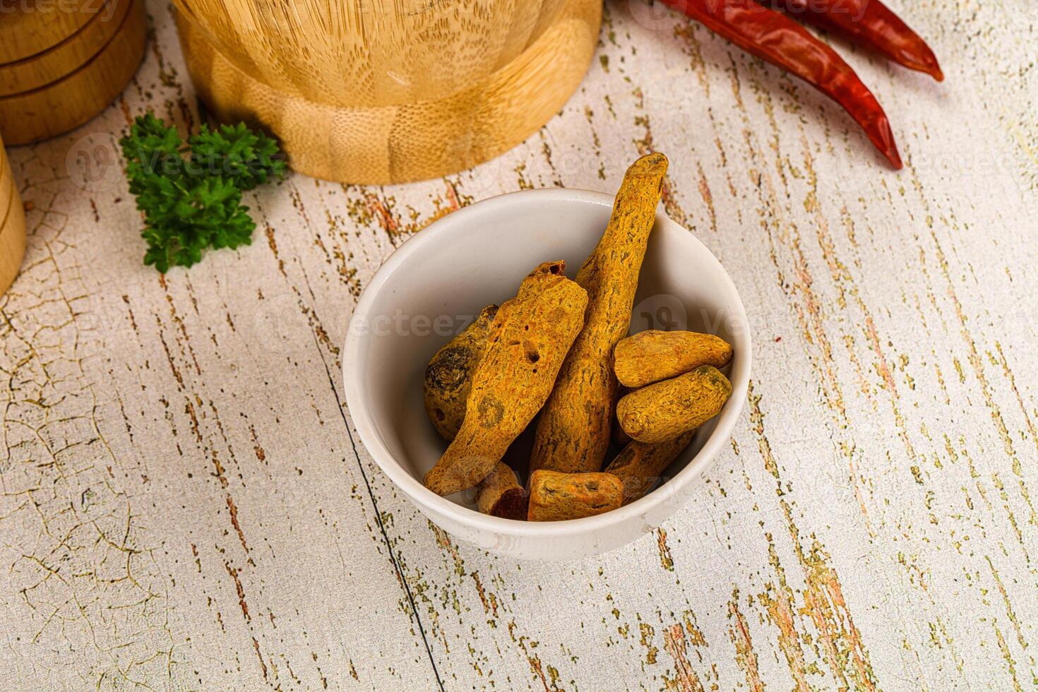 Raw dry Tumeric roots heap photo