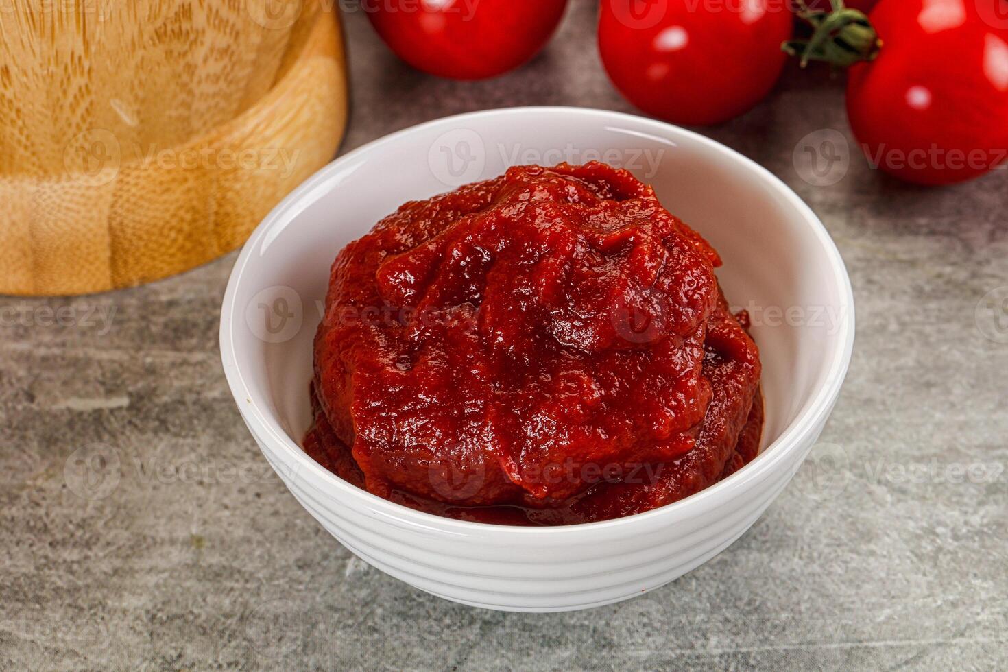 Red tomato paste in the bowl photo
