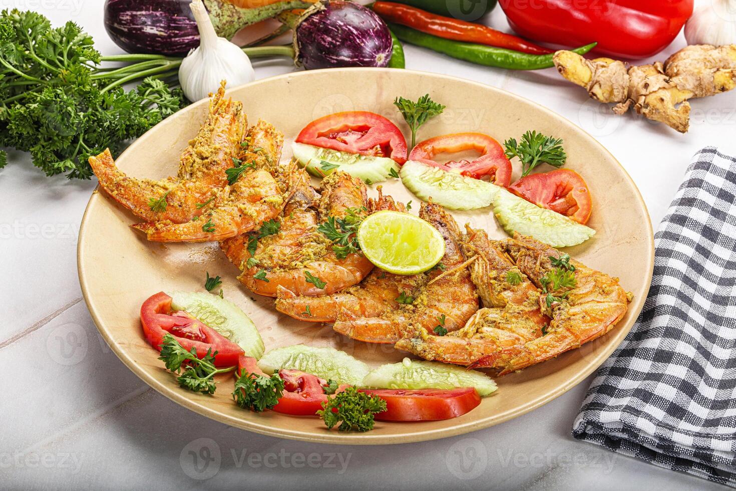 Grilled prawn served lime and vegetables photo