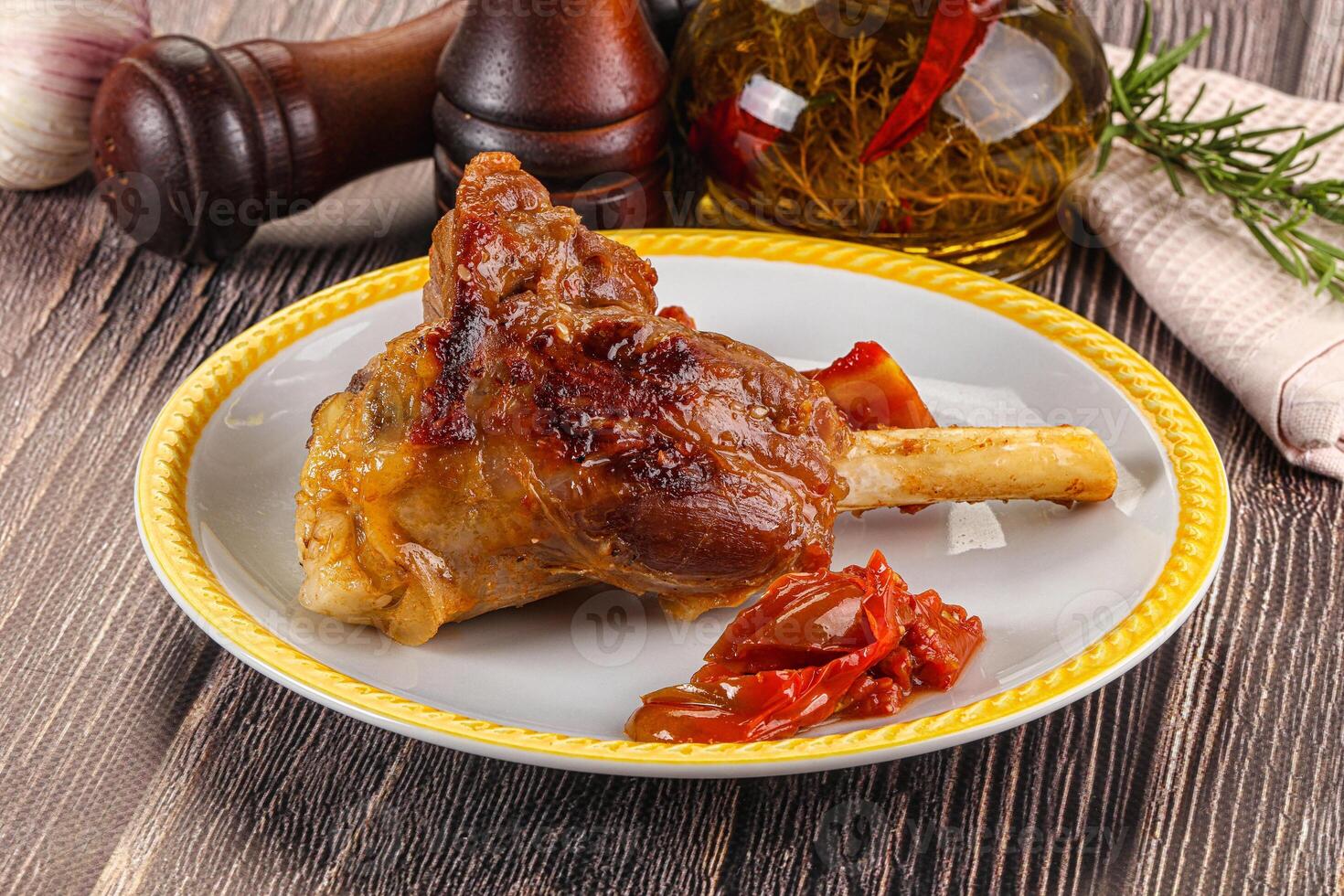 Baked lamb shank with vegetables photo