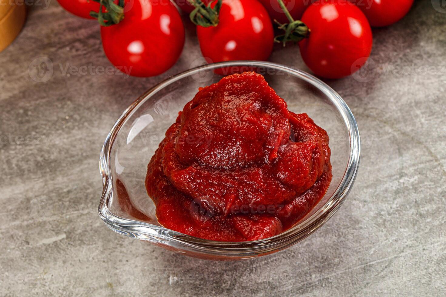 Red tomato paste in the bowl photo