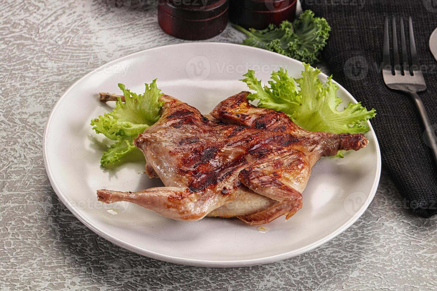 Grilled quail in the plate photo