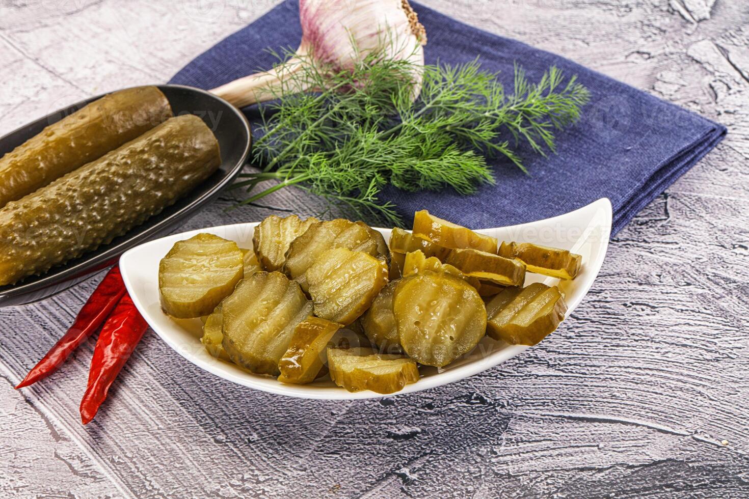 Sliced marinated cucumbers in the bowl photo