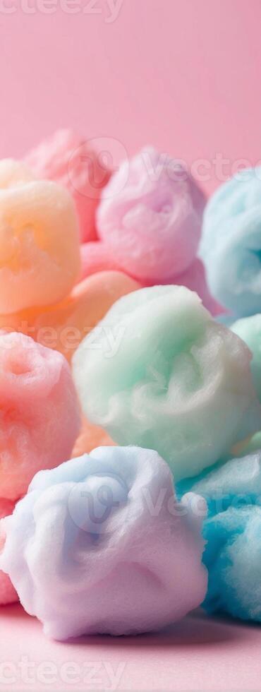 A pile of colorful cotton candy on a pink background photo