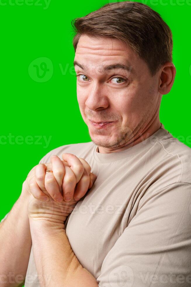A cheerful man with a friendly smile poses against a bright green background photo