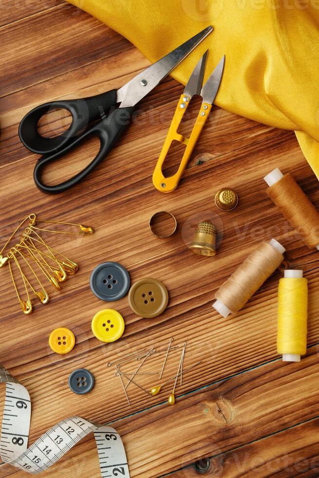 Crafting tools and materials arranged on a wooden table ready for sewing and creative projects photo