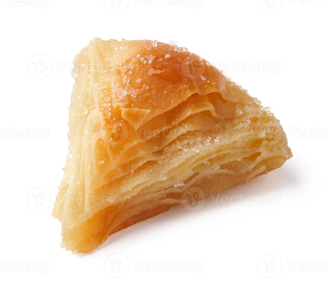 Delicious pastry filled with layers of flaky dough sits on a plain background ready to be enjoyed photo