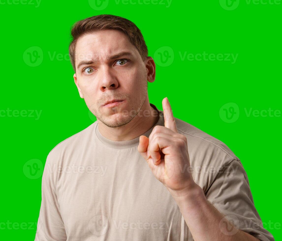 Thoughtful man gestures against a green background photo