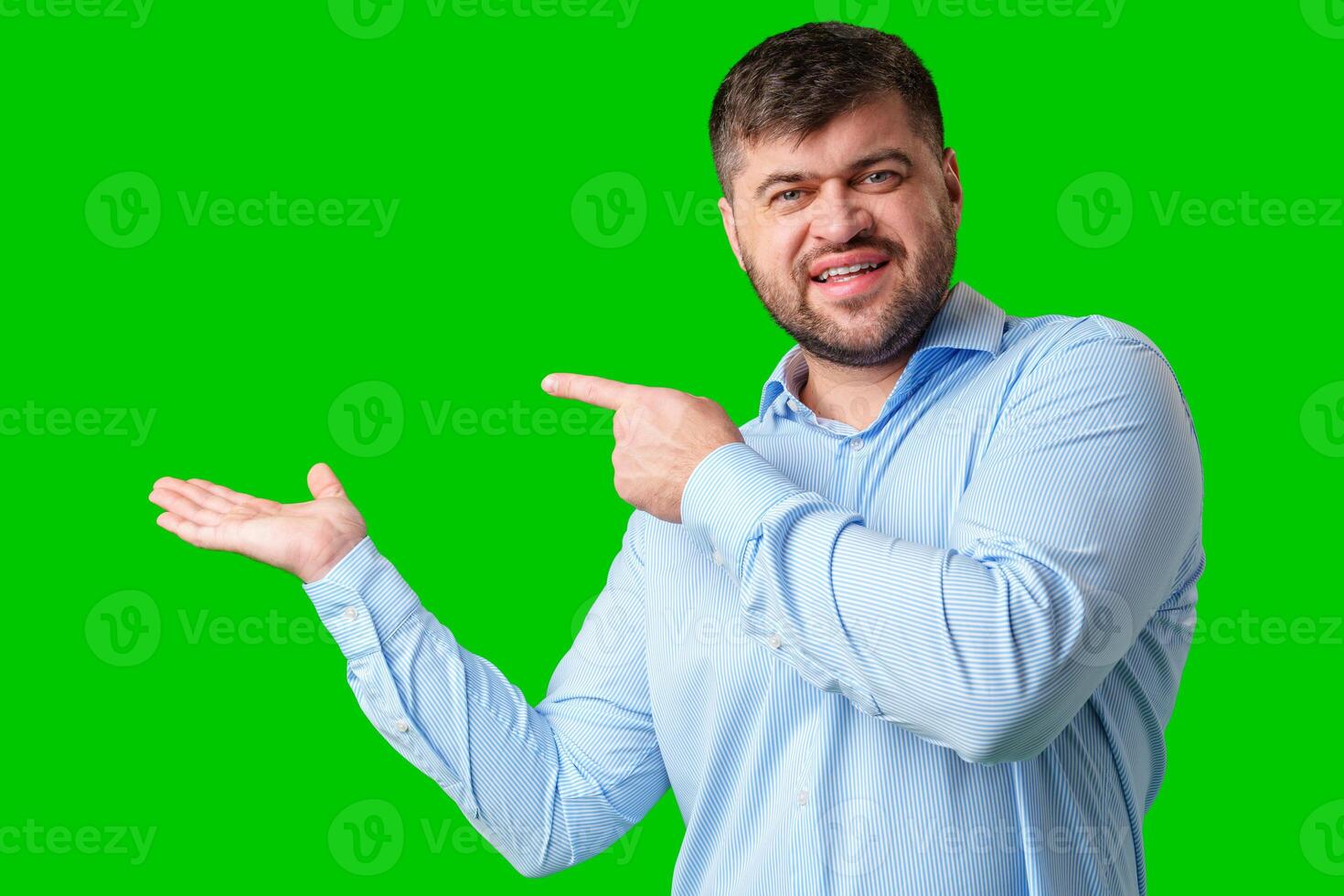 A man gesturing confidently with a bright green background photo