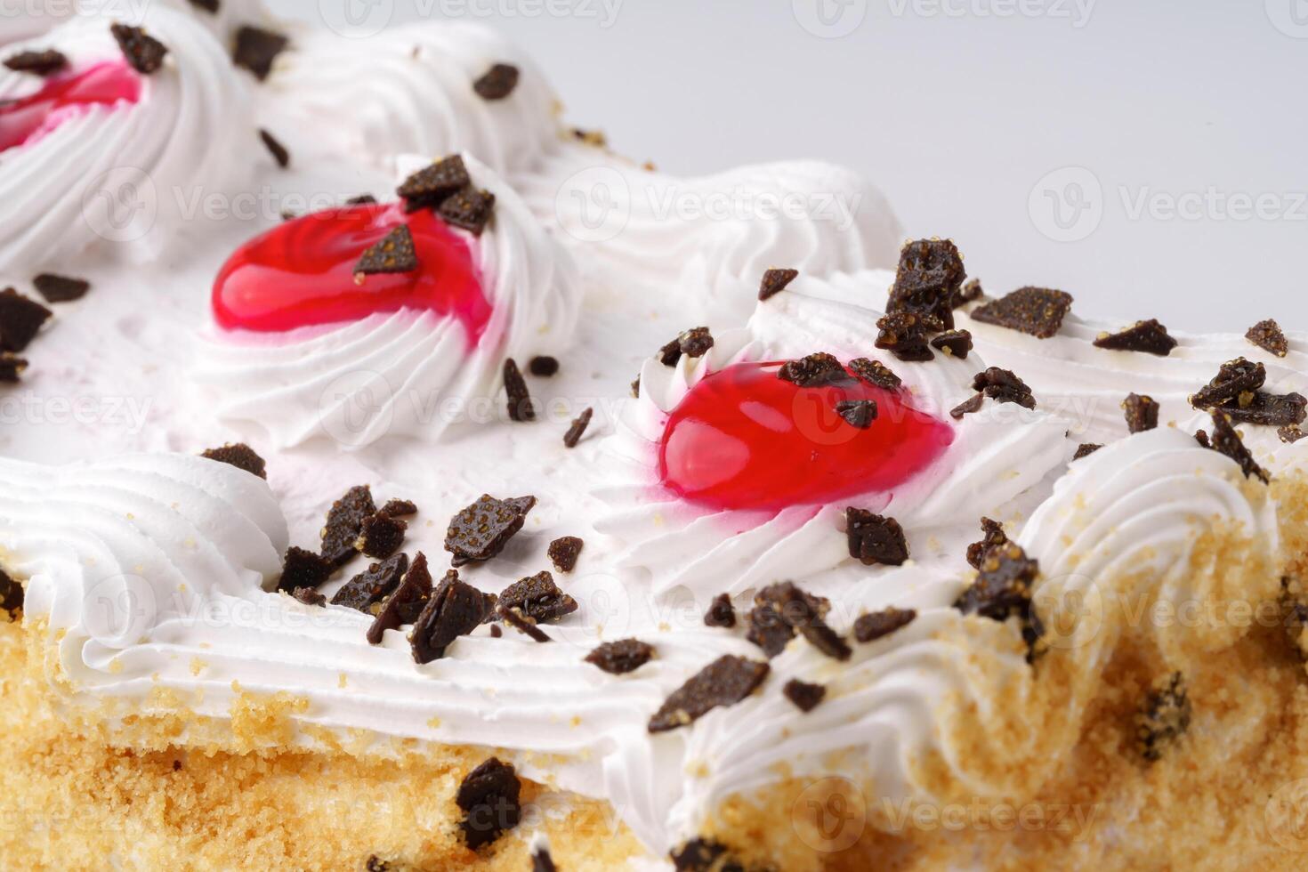 Delicious dessert featuring whipped cream, cherries, and chocolate shavings in a creamy cake setting photo