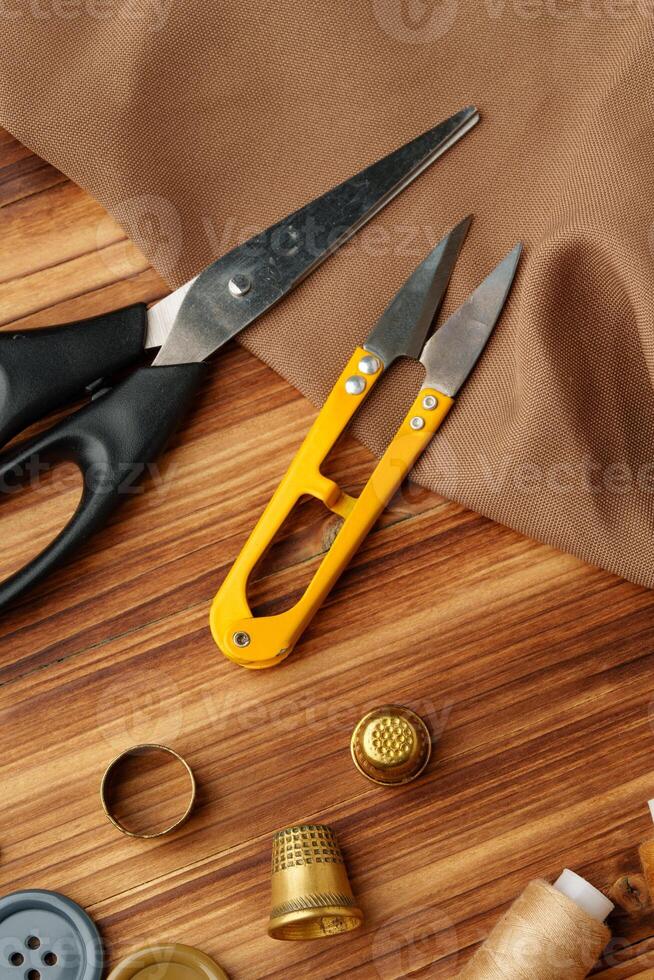 Crafting tools and materials arranged on a wooden table for sewing projects photo