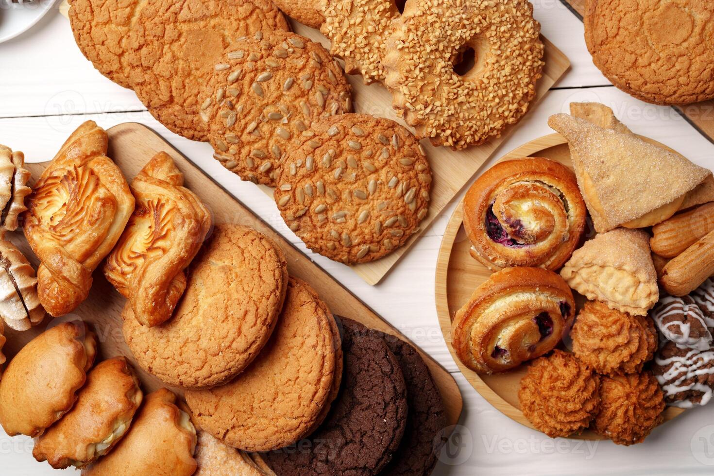 Delicious assortment of baked goods displayed on wooden platters featuring cookies and pastries from a local bakery photo