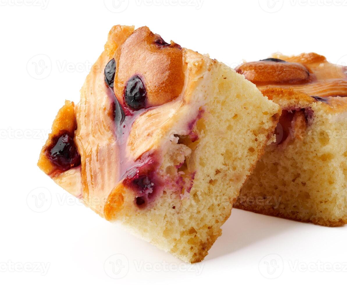 Freshly baked dessert squares with berries on a clean white background ready to be enjoyed photo