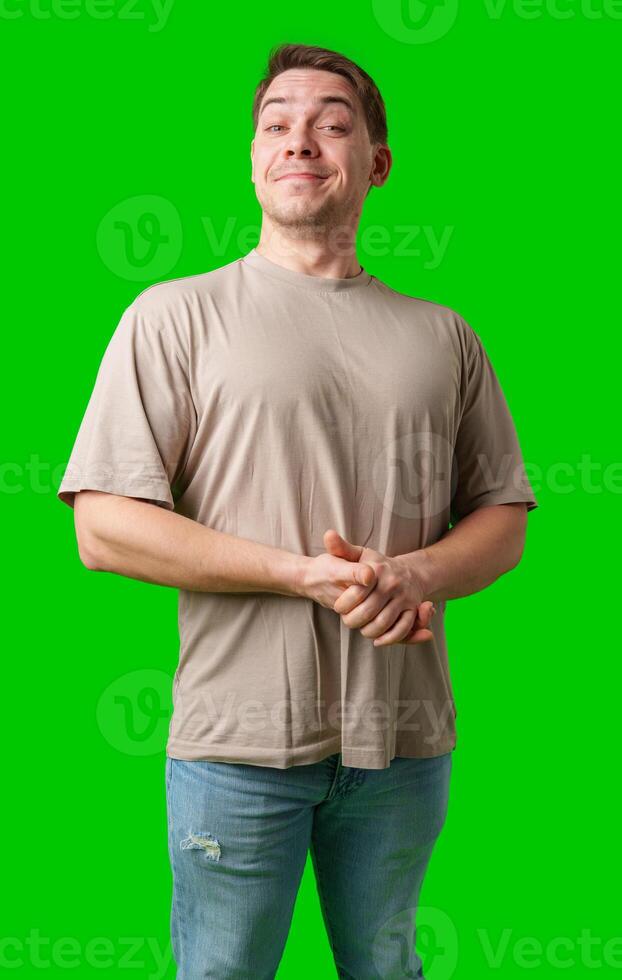 A cheerful man with a friendly smile poses against a bright green background photo