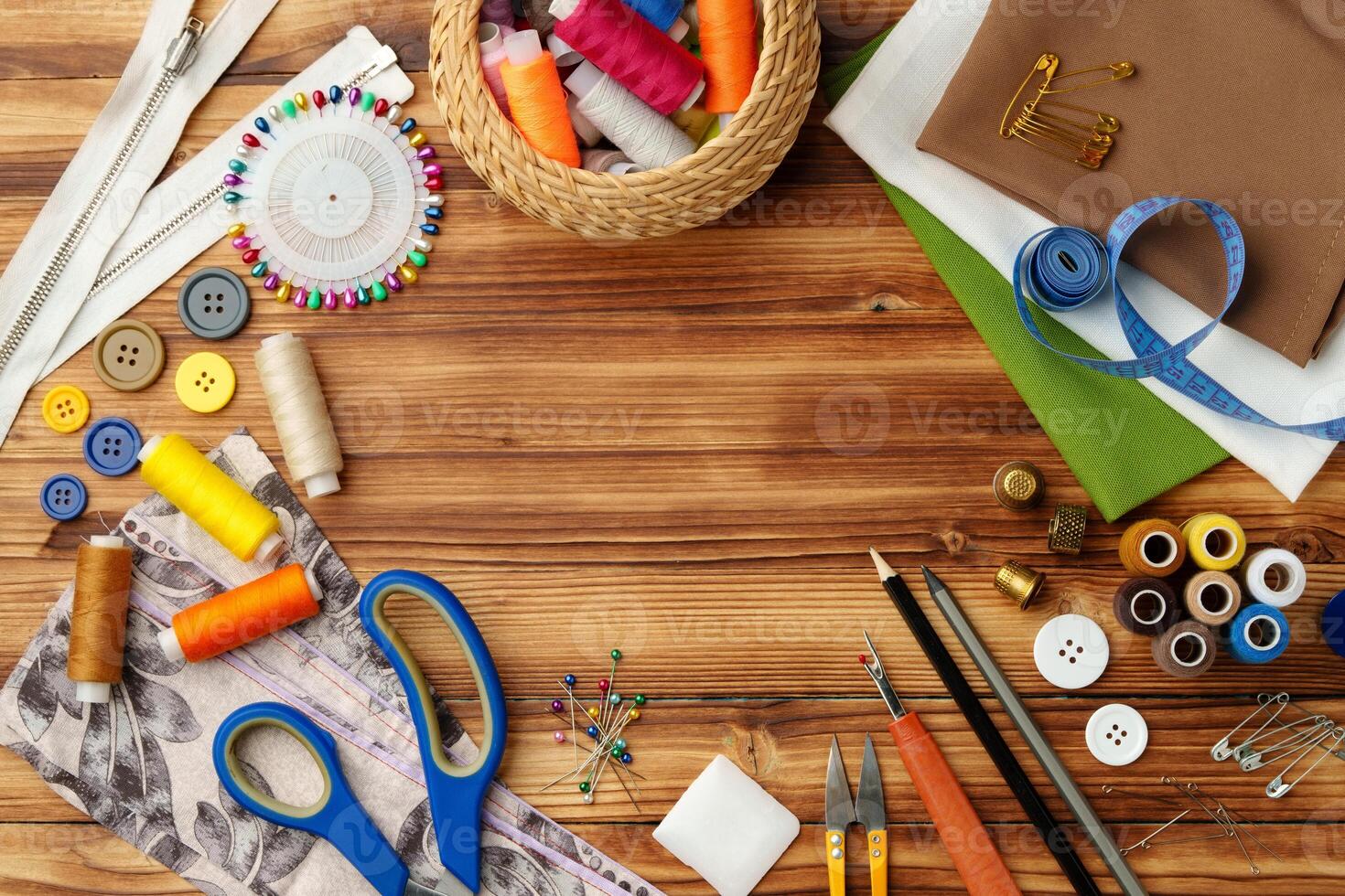 Crafting tools and materials arranged on a wooden table for sewing projects photo