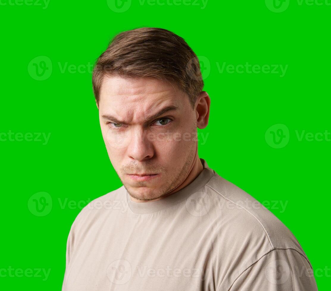 Intense expression captured against a bright green background photo