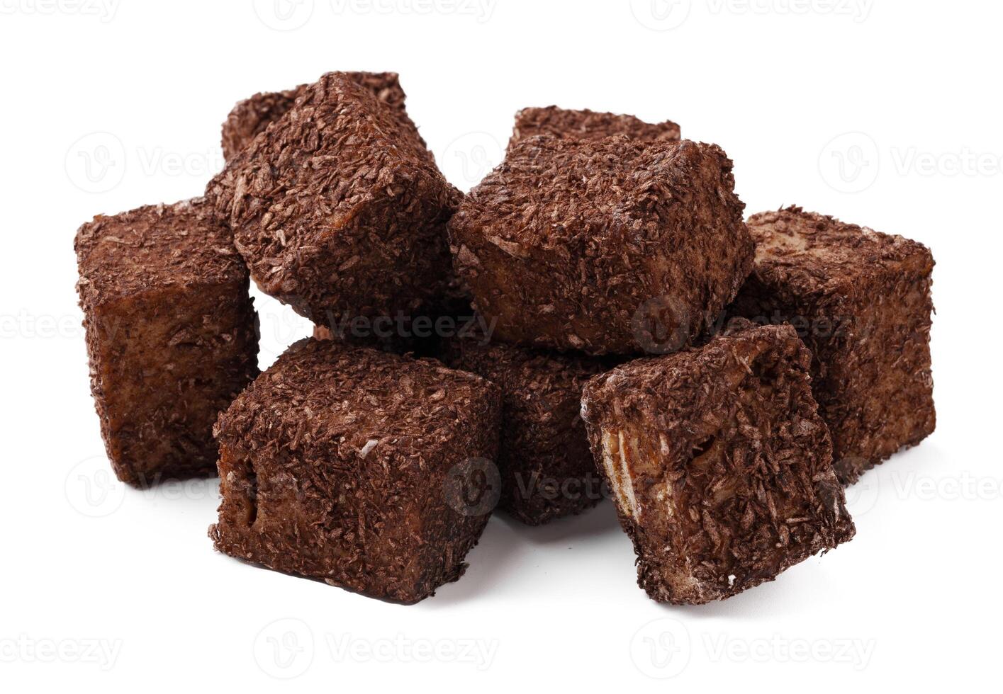 Delicious dark chocolate cubes stacked on a white background ready for dessert or snacking photo