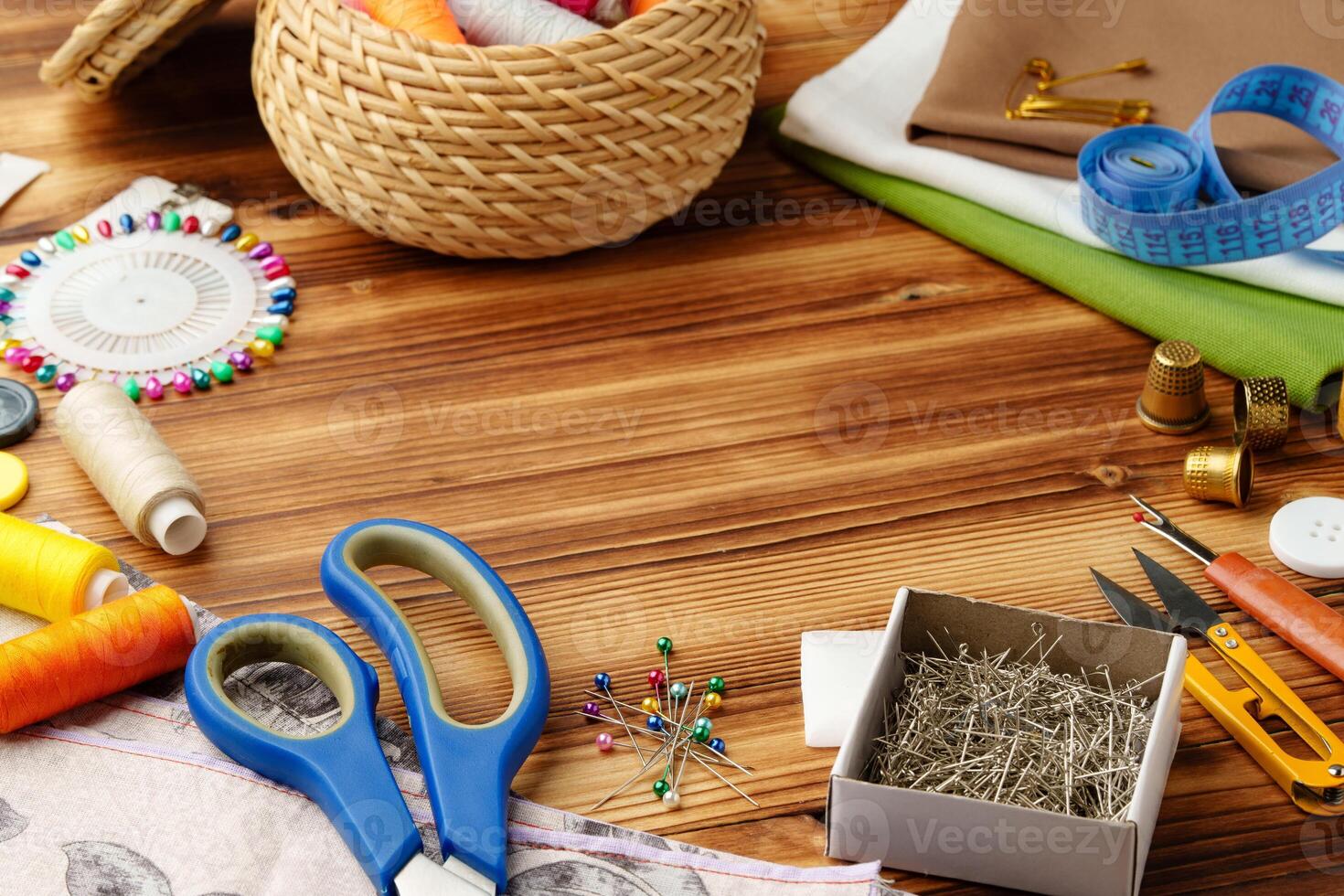 Crafting tools and materials arranged on a wooden table for sewing projects photo