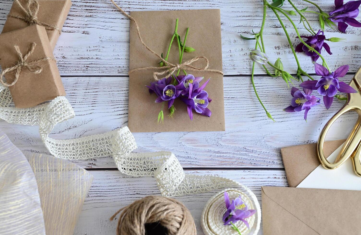 Pink and blue flowers, postcard, kraft, twine. Layout of Women's Day or Mother's Day, St. Valentine's Day, flat, top view. photo