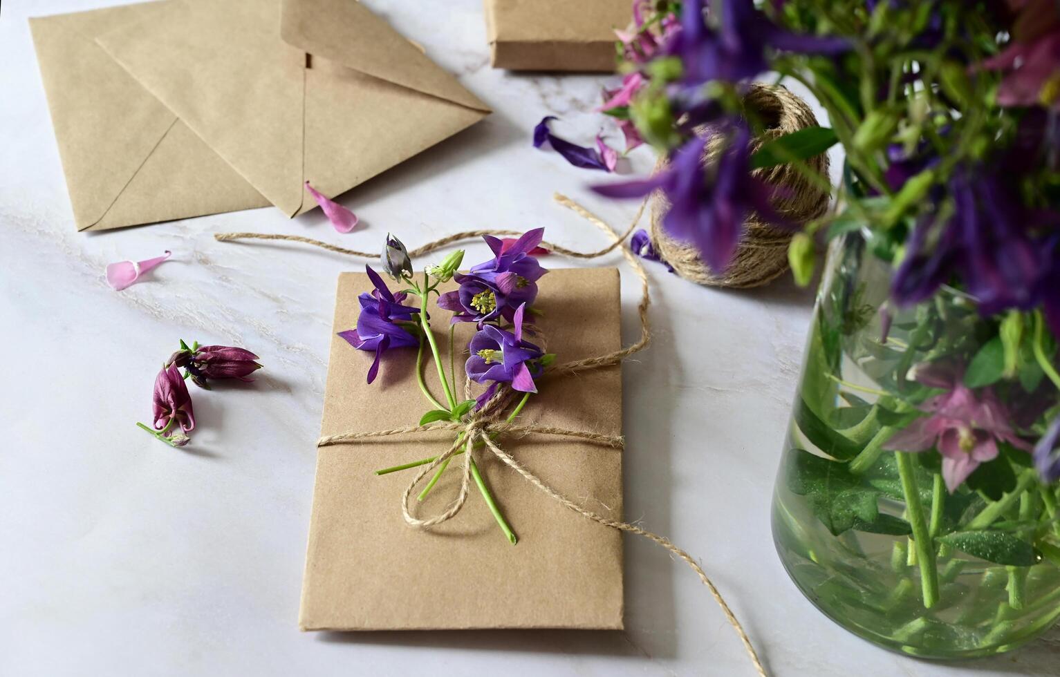 Pink and blue flowers, postcard, kraft, twine. Layout of Women's Day or Mother's Day, St. Valentine's Day, flat, top view. photo