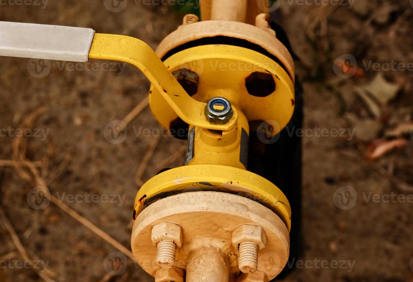 yellow gas pipe with a crane goes along the facade of a new multi-storey building. House connected to gas for domestic use photo