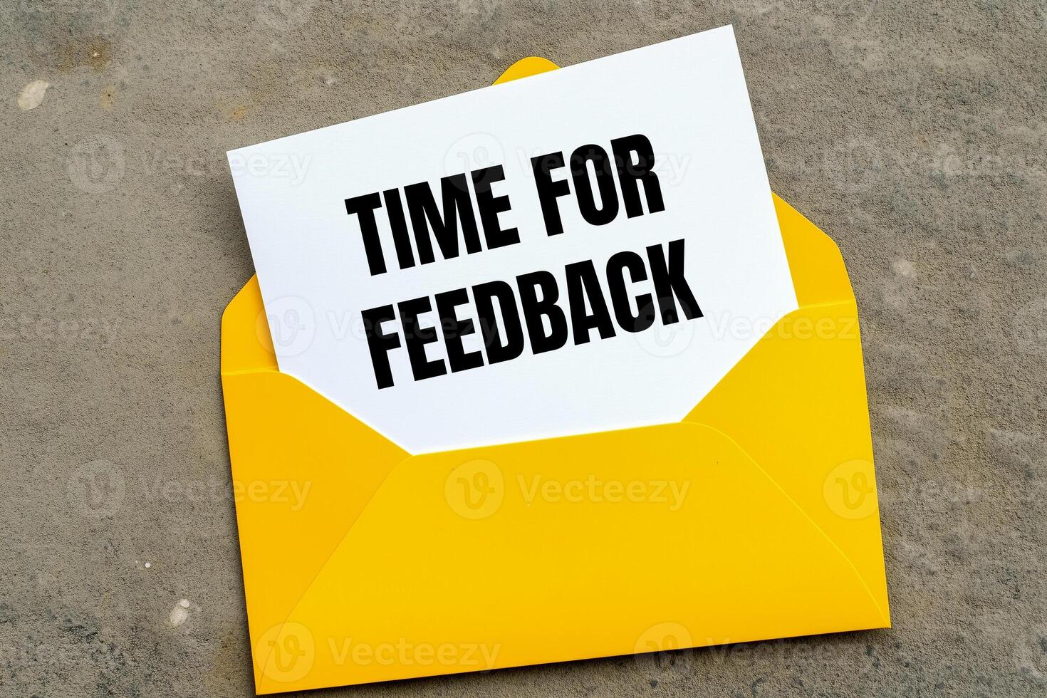 Time for feedback message written on yellow envelope. Conceptual time for feedback symbol. Copy space. photo
