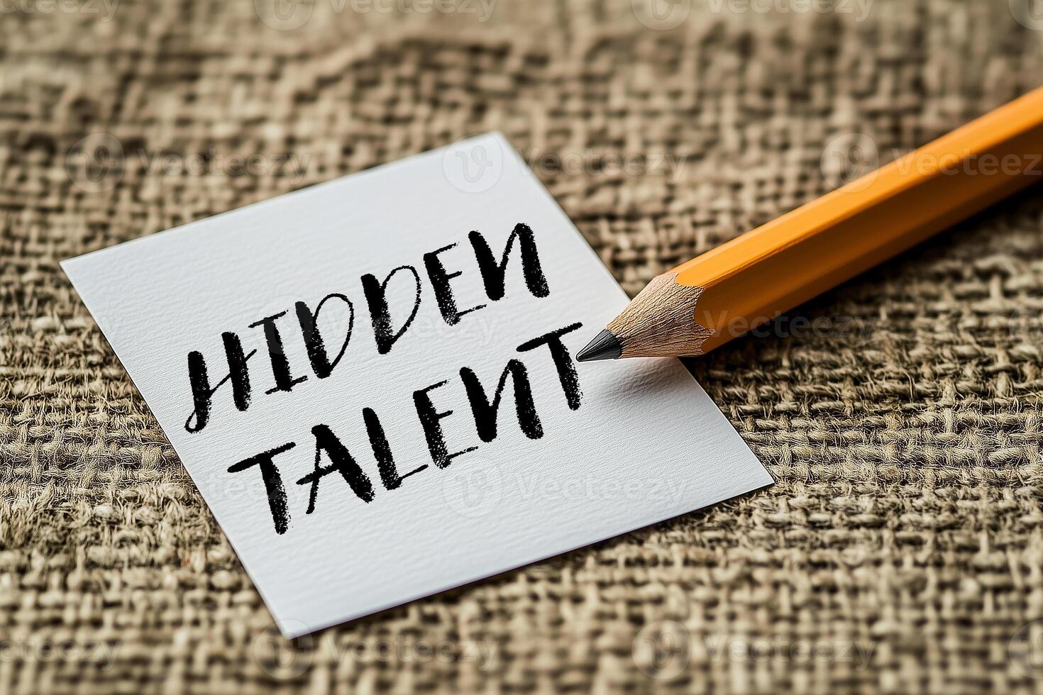Hidden talent message written on a white card with pencil. Conceptual hidden talent symbol. Copy space. photo