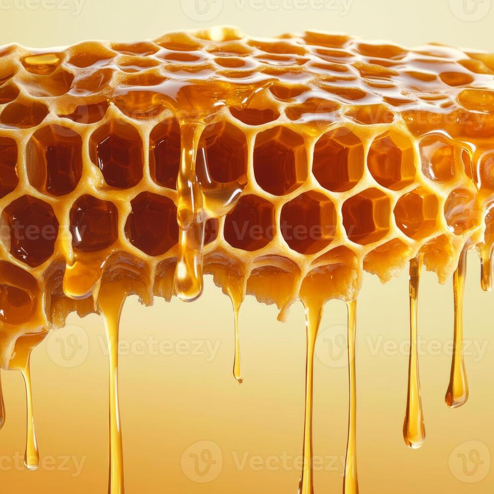 Golden honeycomb dripping with fresh honey against warm background, showcasing natural beauty and sweetness of honey. hexagonal pattern is highlighted by light photo