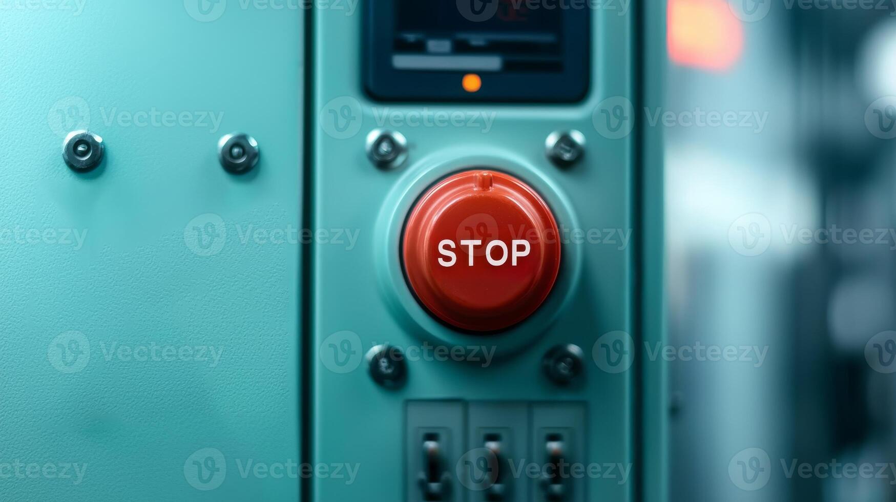 Safety guidelines for manufacturing. Red stop button on a teal control panel. photo
