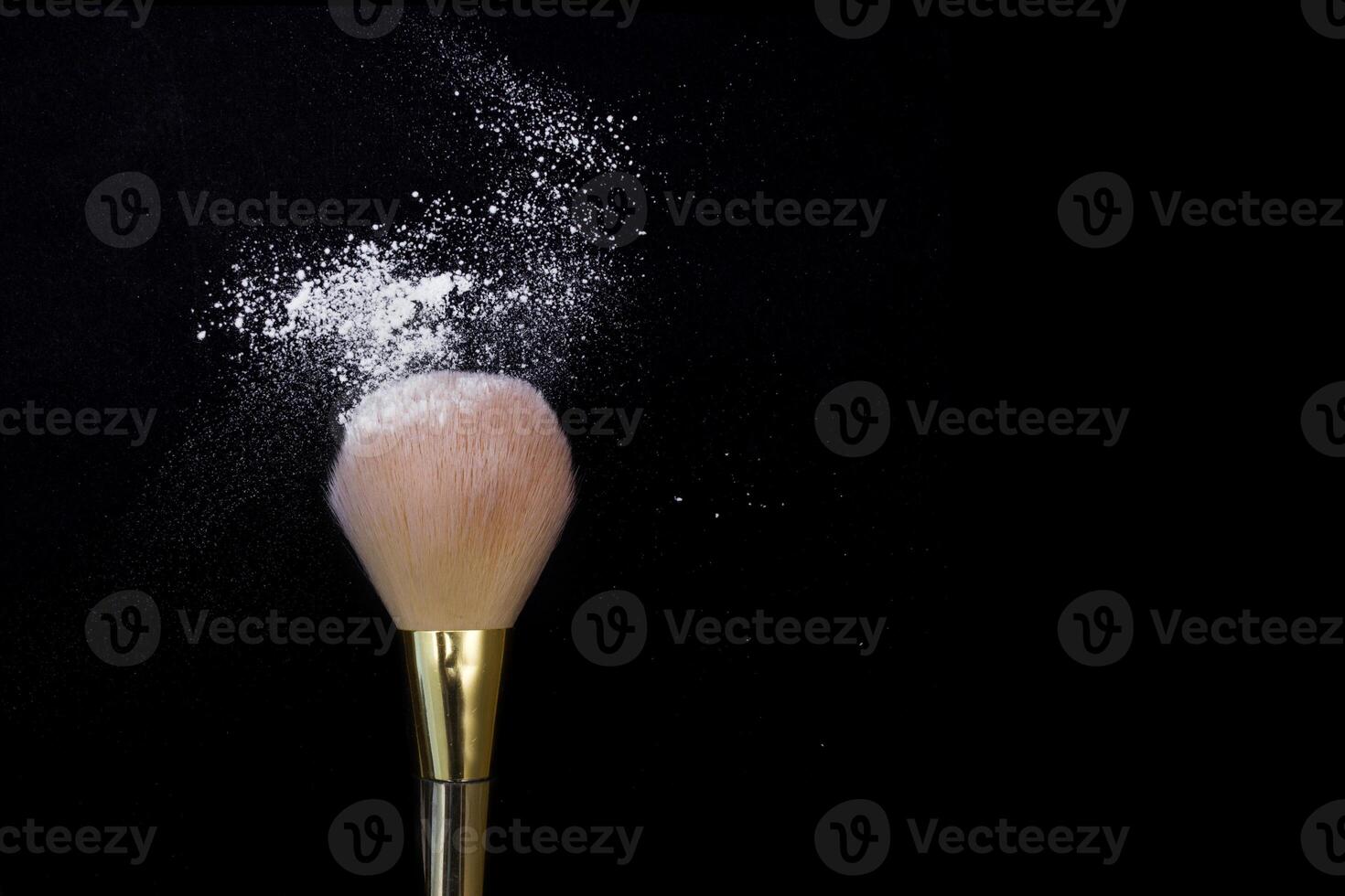 Make up brush with powder isolated on black background. photo
