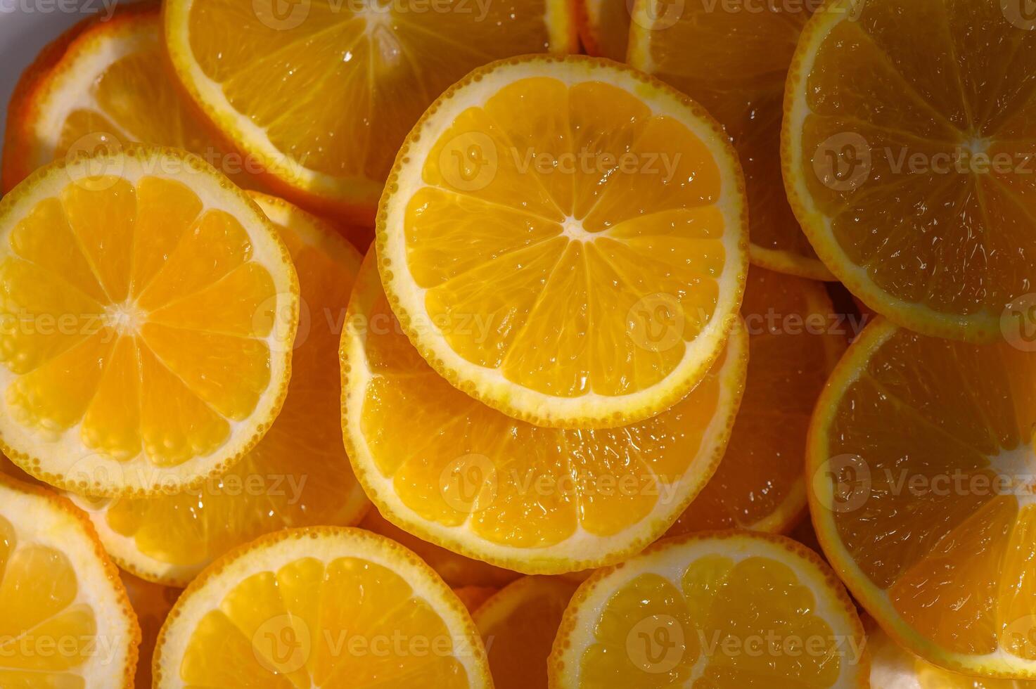 Bright slices of fresh oranges arranged artfully in a bowl capture the essence of summer vibrance and flavor photo