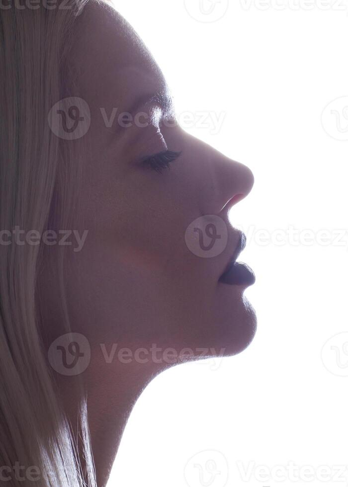 Beautiful woman applying spray water on face photo