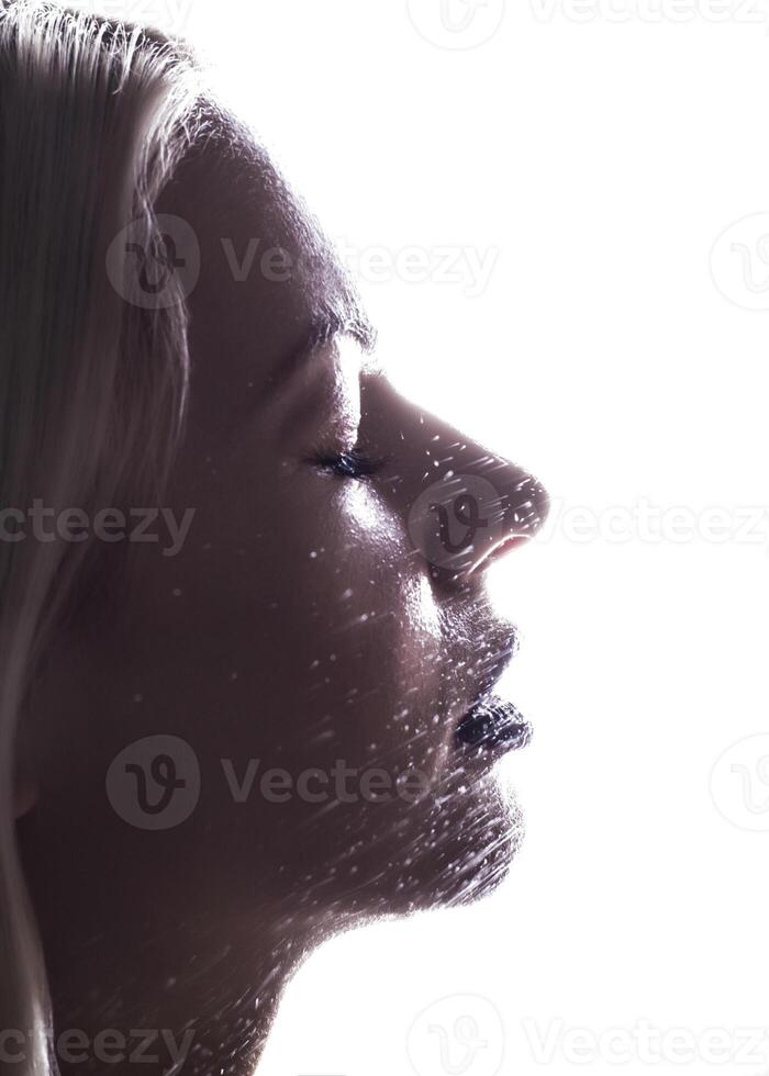 Beautiful woman applying spray water on face photo