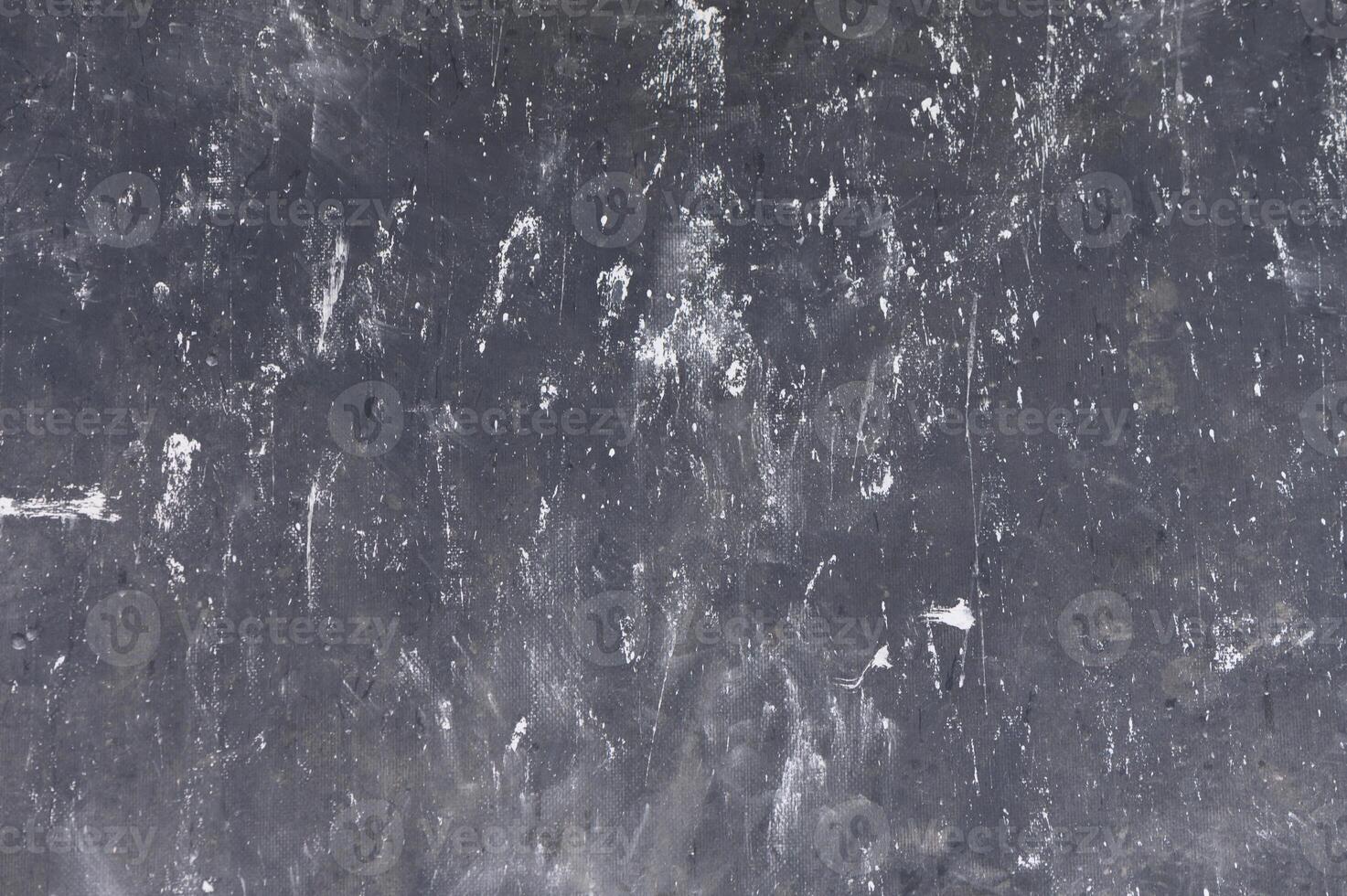 Dark textured surface reveals intricate patterns of wear and use in a creative workspace environment photo