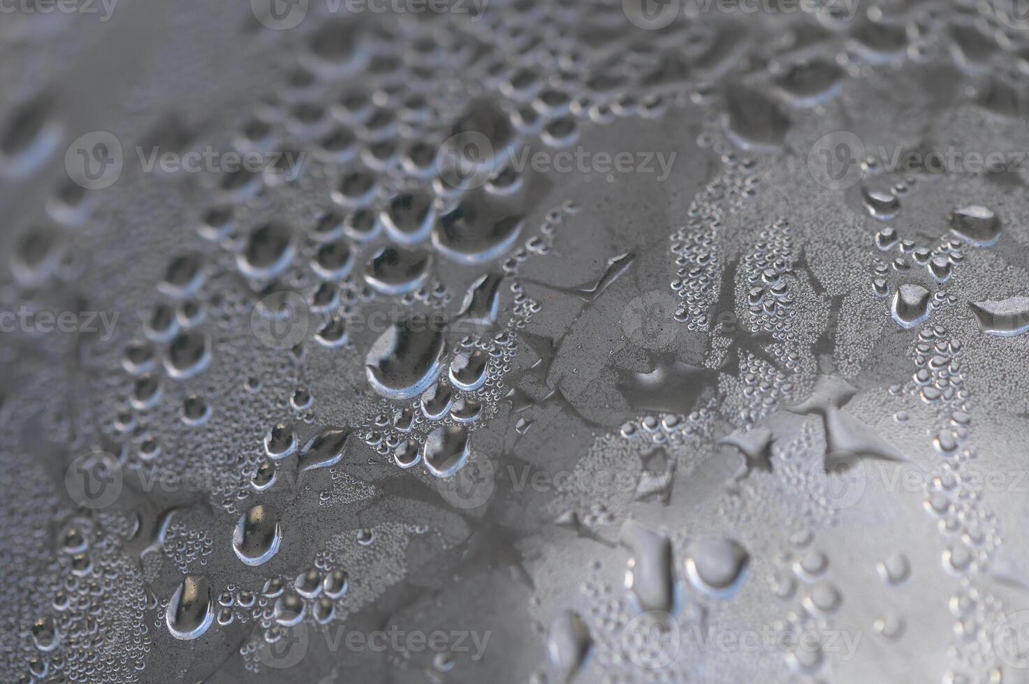 Droplets of water glisten on a metallic surface after a refreshing rain shower at dawn photo