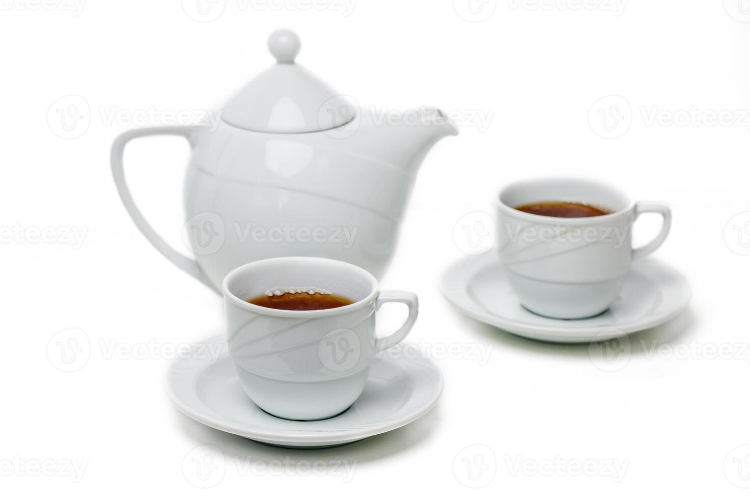 Elegant white tea set with steaming cups on saucers surrounded by tranquility of afternoon tea time photo