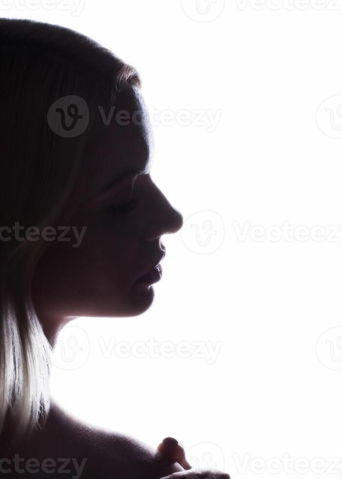 Silhouette of a woman s face on a white background photo