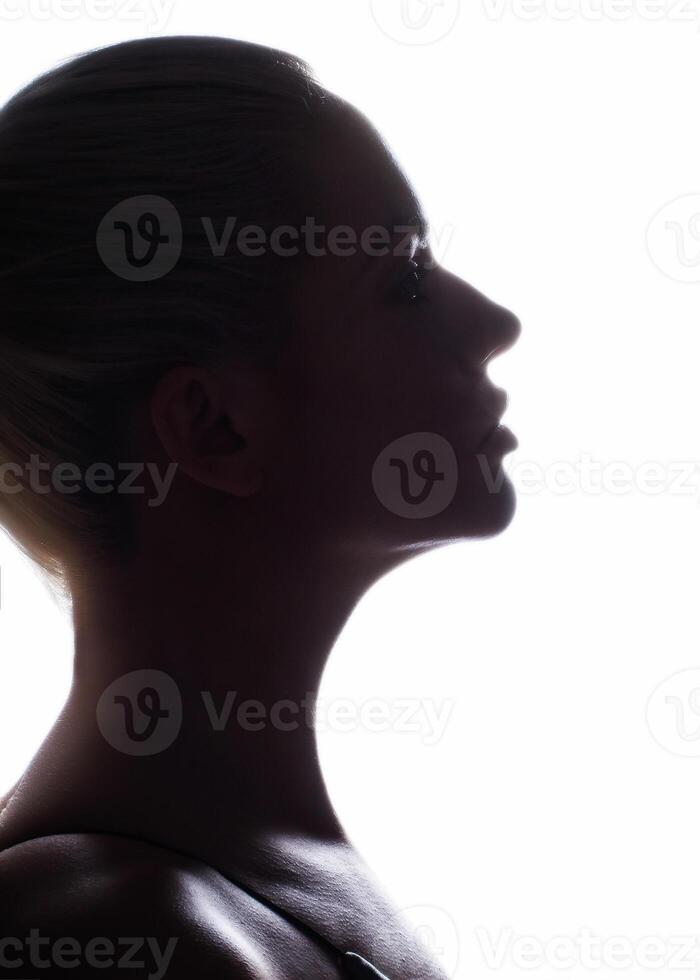 Silhouette of a woman s face on a white background photo